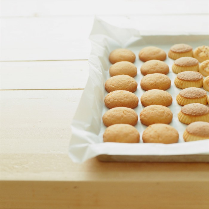 A tray of cookies cooling on parchment