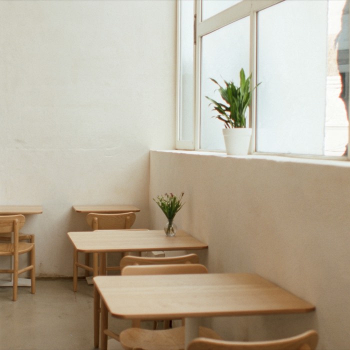 Oak tables and chairs in the corner of the room